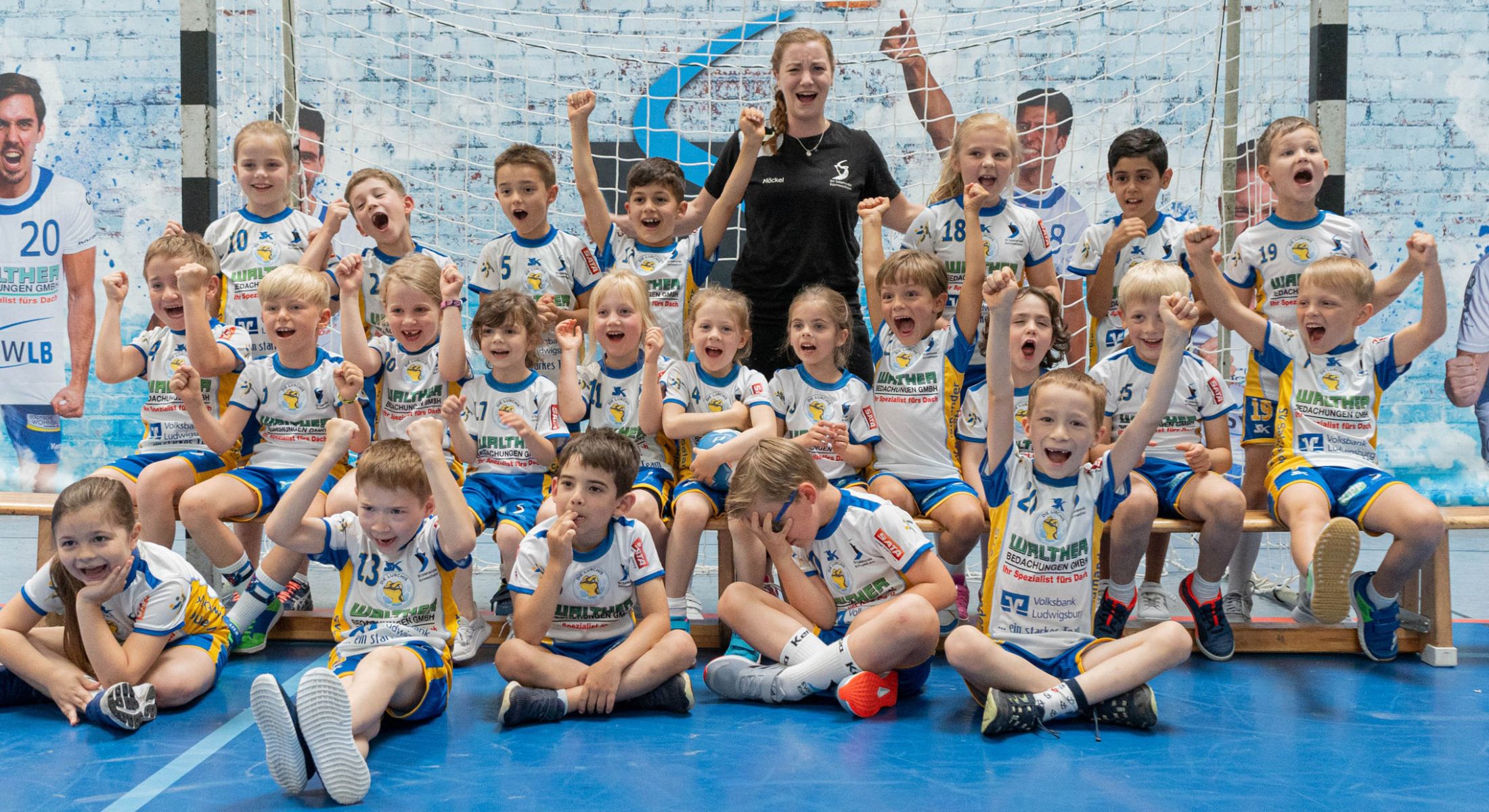 Jugend-Handballteam des SV Kornwestheim jubelt gemeinsam mit Trainerin in der Sporthalle.